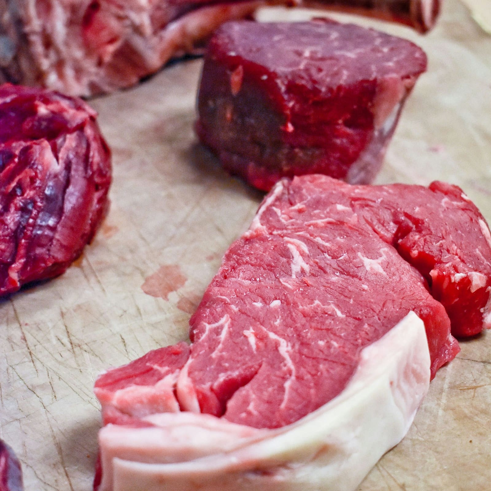 Fresh-cut steaks on the butcher's board
